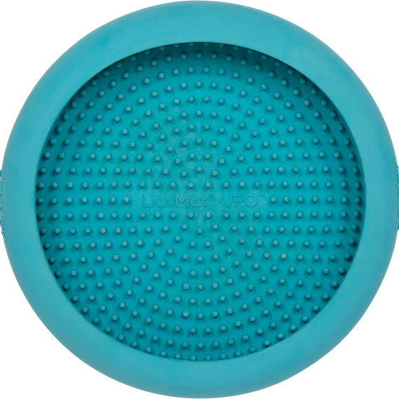 LickiMat UFO in turquoise stuck to a wall