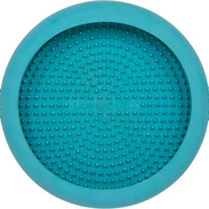 LickiMat UFO in turquoise stuck to a wall
