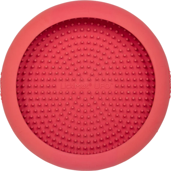LickiMat UFO in pink stuck to a surface