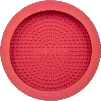 LickiMat UFO in pink stuck to a surface