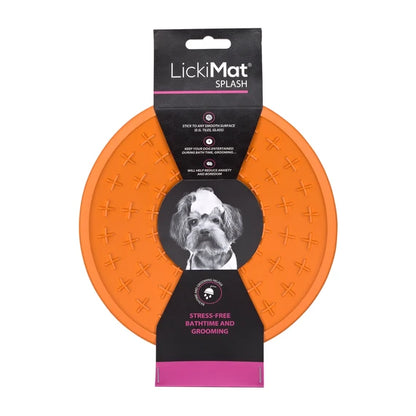 LickiMat Splash in orange stuck to a wall