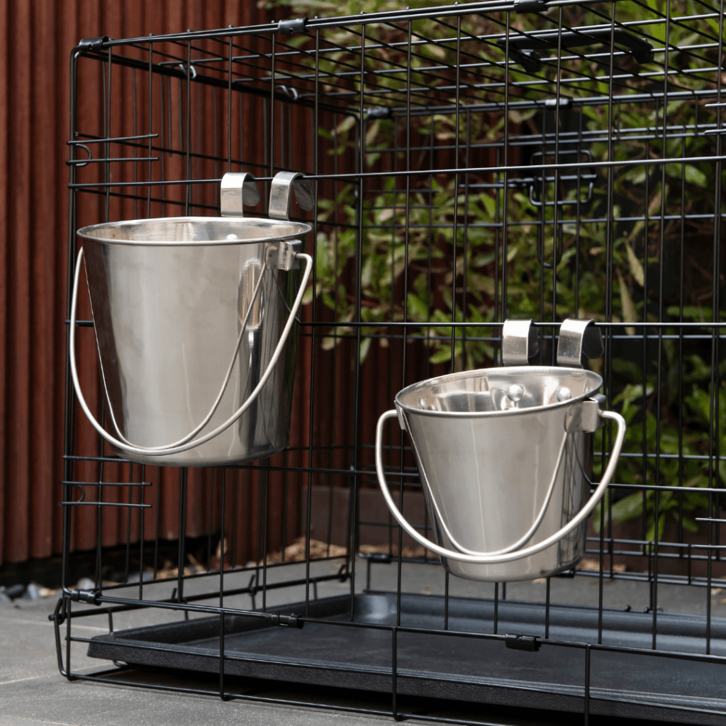 Superior Pet stainless steel bucket shown mounted in a kennel