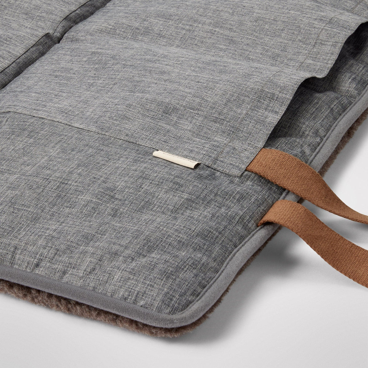 Dog lying on the Travel Swag beside an outdoor cafe table